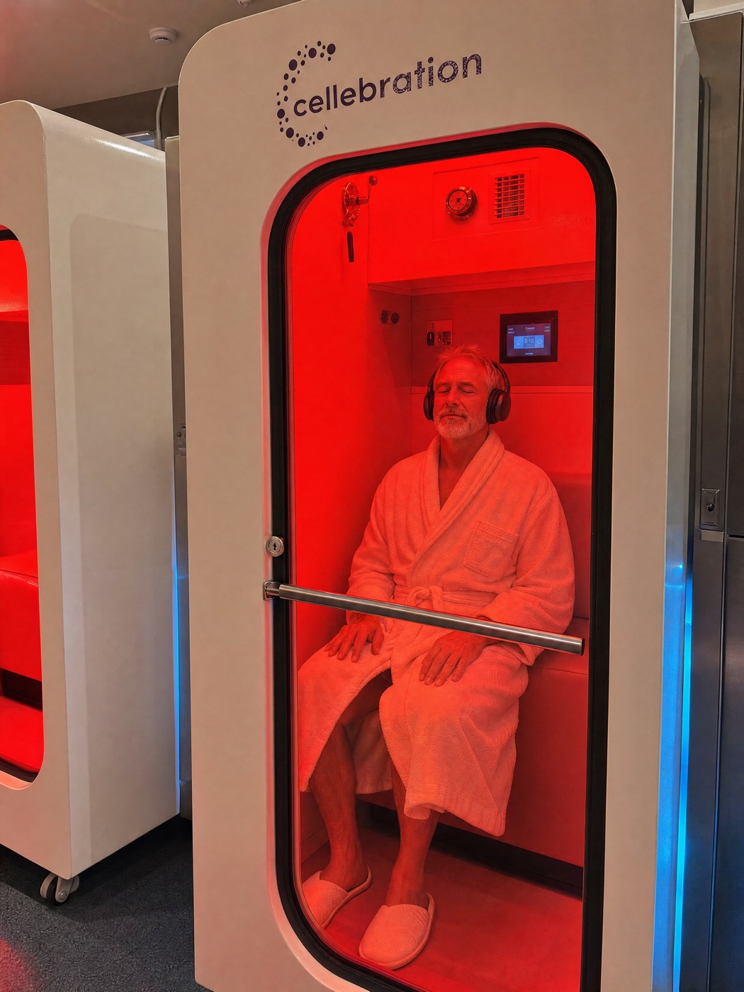 A man resting with headphones inside a Cellebration hard-shell hyperbaric chamber