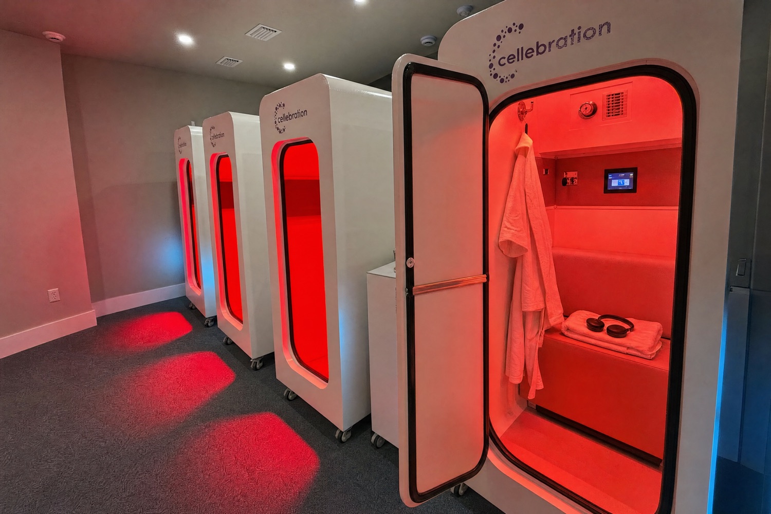 An open Cellebration hyperbaric chamber with a robe and headphones on the seat